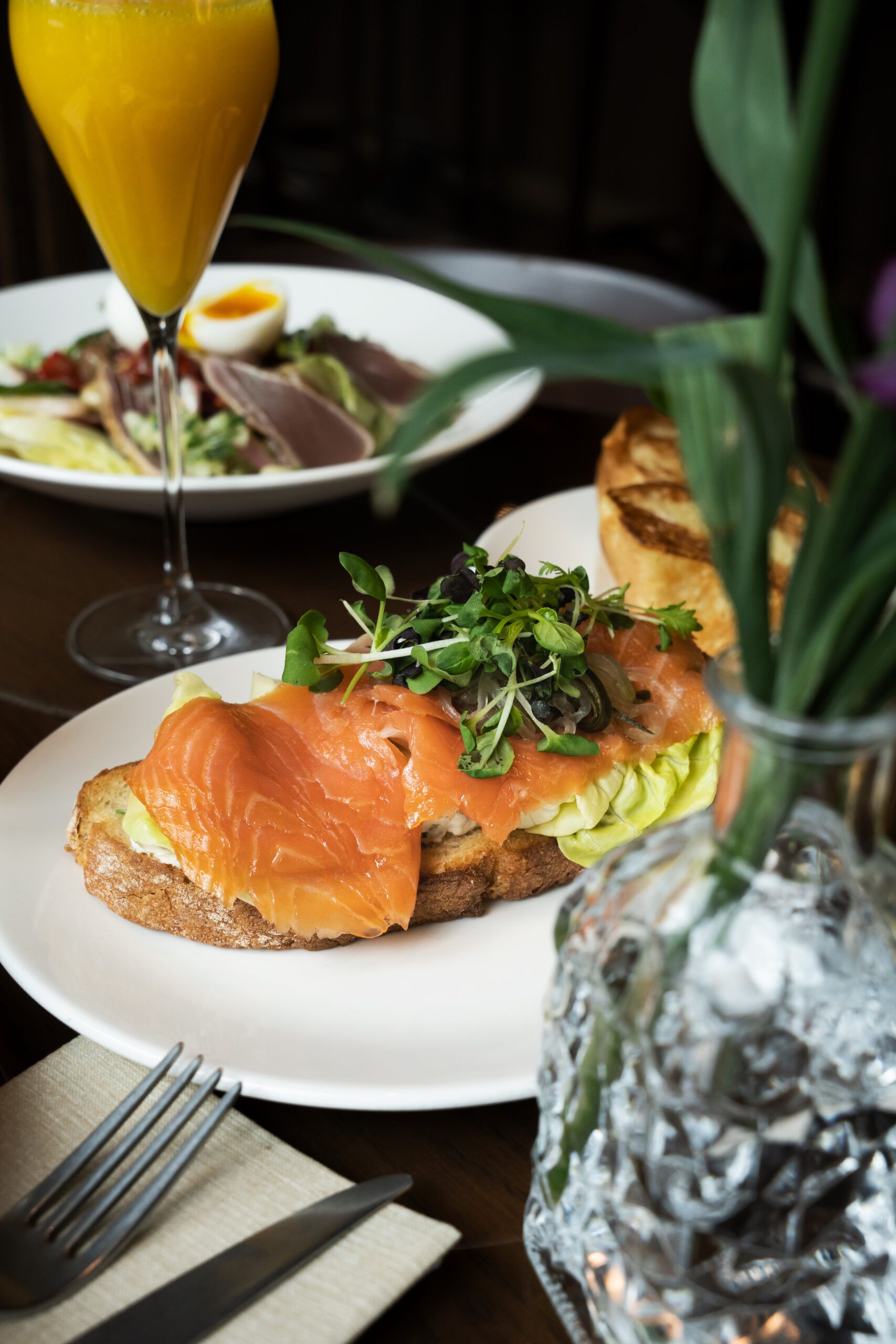 Smoked salmon on toast with a salad and a glass of fresh orange juice
